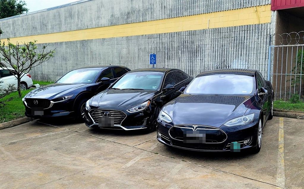 Repaired cars parked outside Nova Body Shop, ready for pickup